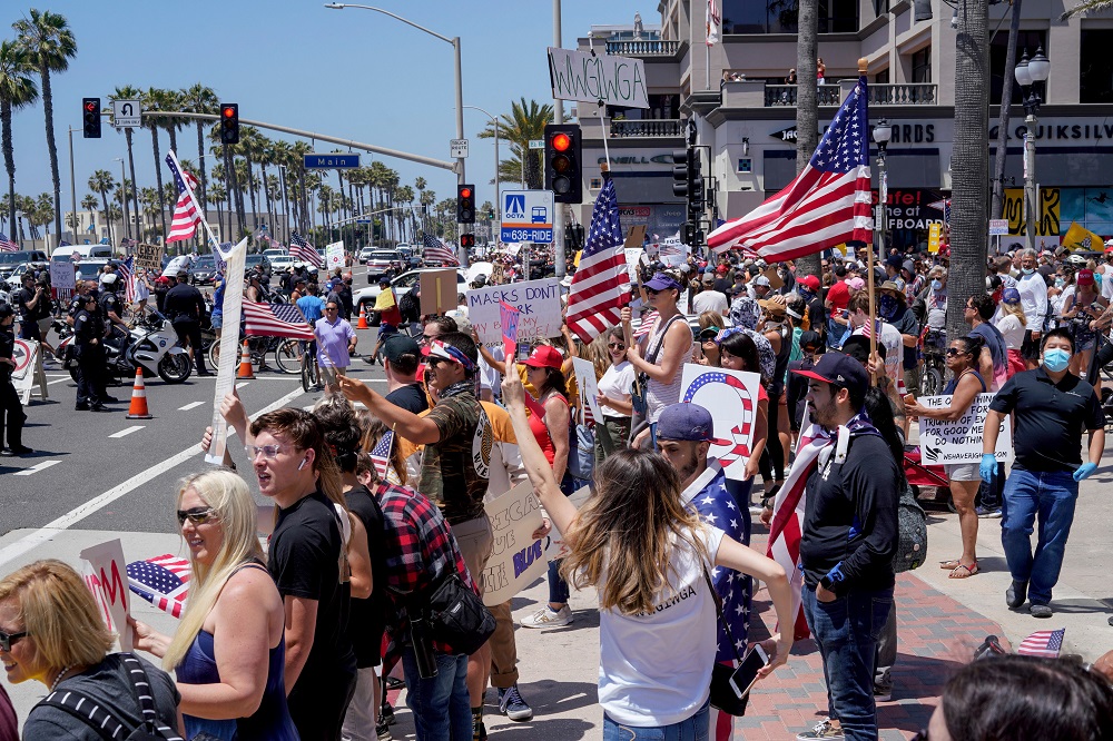 People gather near Huntington Beach Pier to protest Governor Gavin Newsom’s order to temporarily close state and local beaches in Orange County, California May 1, 2020. — Reuters pic