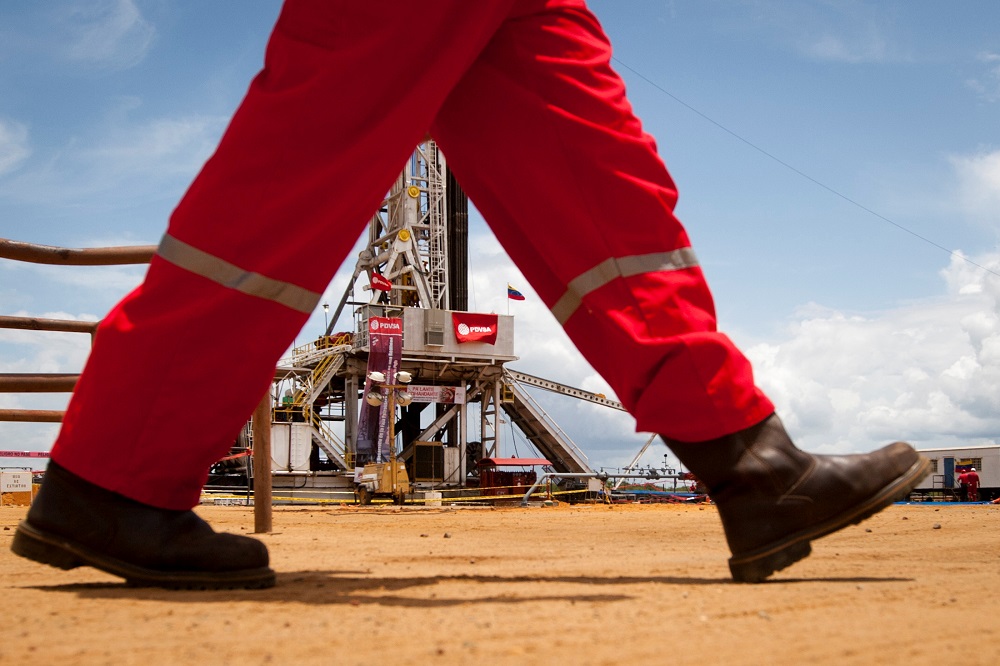 An oil worker walks past a drilling rig at an oil well operated by Venezuelau00e2u20acu2122s state oil company PDVSA in Morichal July 28, 2011. u00e2u20acu201d Reuters pic