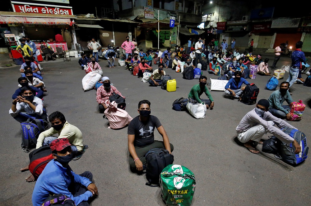 Migrant workers, who were stranded in the western state of Gujarat due to a lockdown imposed by the government sit on a road as they wait to board a train that will take them to their home state of Bihar, in Ahmedabad May 4, 2020. u00e2u20acu201d Reuters pic