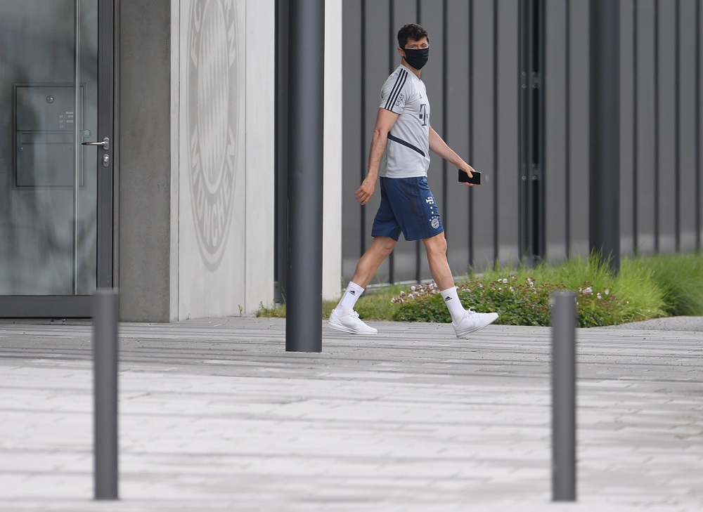 Bayern Munich's Robert Lewandowski wears a protective mask as he boards a bus for the training ground in Munich May 5, 2020. u00e2u20acu201d Reuters pic