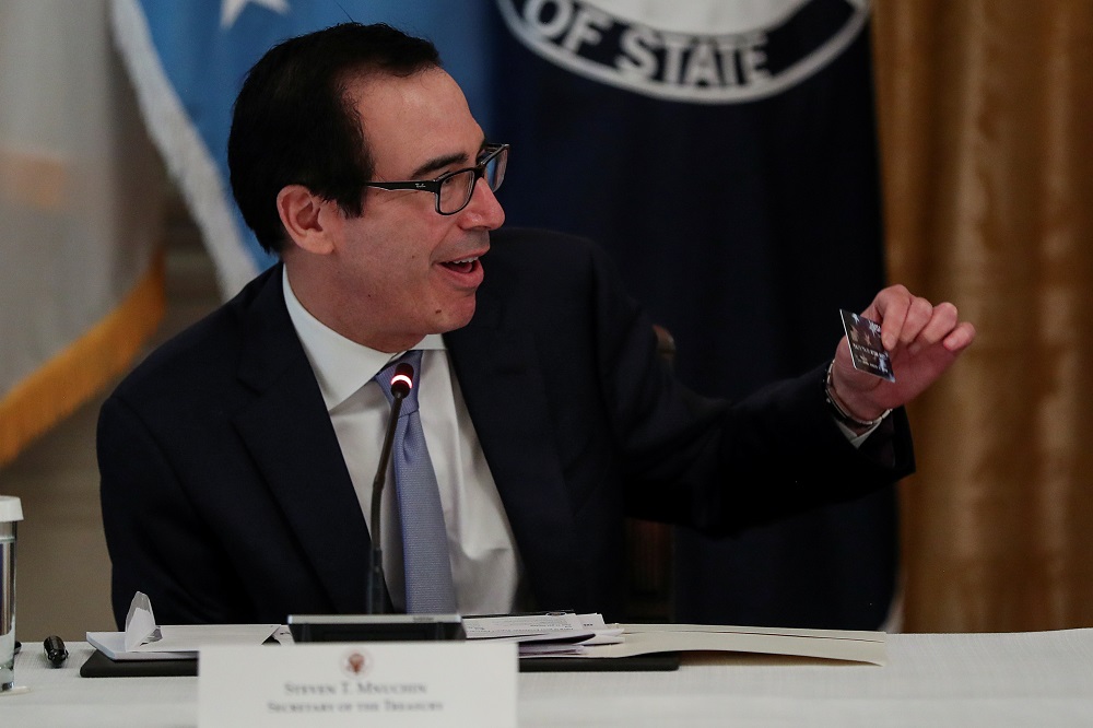 Treasury Secretary Steven Mnuchin shows a Covid-19 pandemic relief debit card prior to handing it to US President Donald Trump during a Cabinet meeting at the White House in Washington May 19, 2020. u00e2u20acu201d Reuters pic