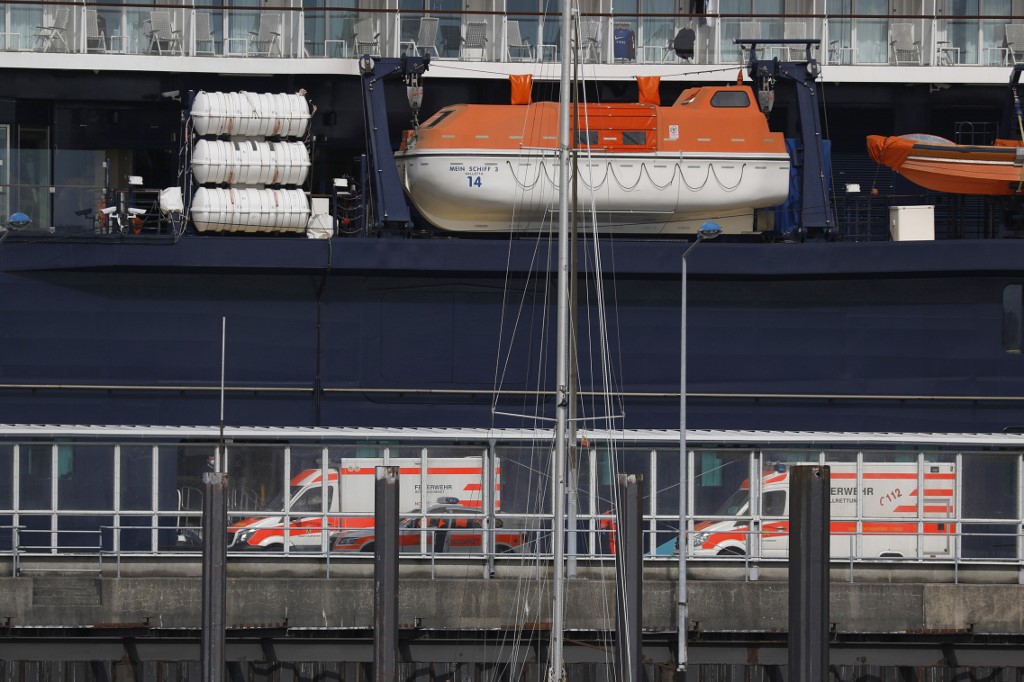 Ambulances park next to he cruise ship 'Mein Schiff 3', operated by German tour operator TUI as it is seen at its dock in the harbour of the northern German city of Cuxhaven, on May 2, 2020. u00e2u20acu201d AFP picn n