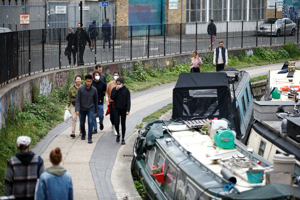 General view of people some with protective face masks at Regent's Canal, following the outbreak of the coronavirus disease (COVID-19), London May 3, 2020. u00e2u20acu201d Reuters picnn