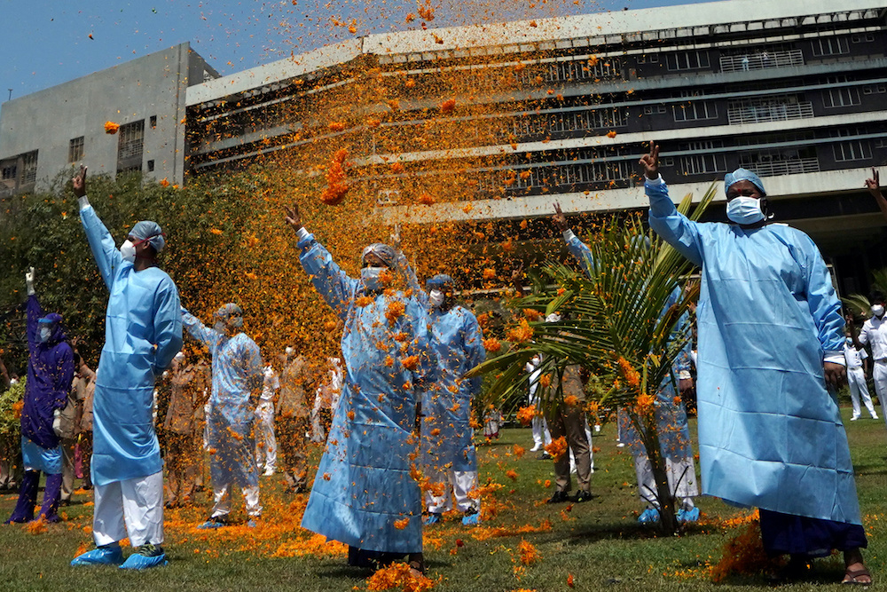 The staff of INHS Asvini hospital are showered with flower petals by Indian Navy's Chetak helicopter as part of an event to show gratitude towards the frontline warriors fighting the coronavirus disease (Covid-19) outbreak, in Mumbai May 3, 2020. u00e2u20acu201d Reut