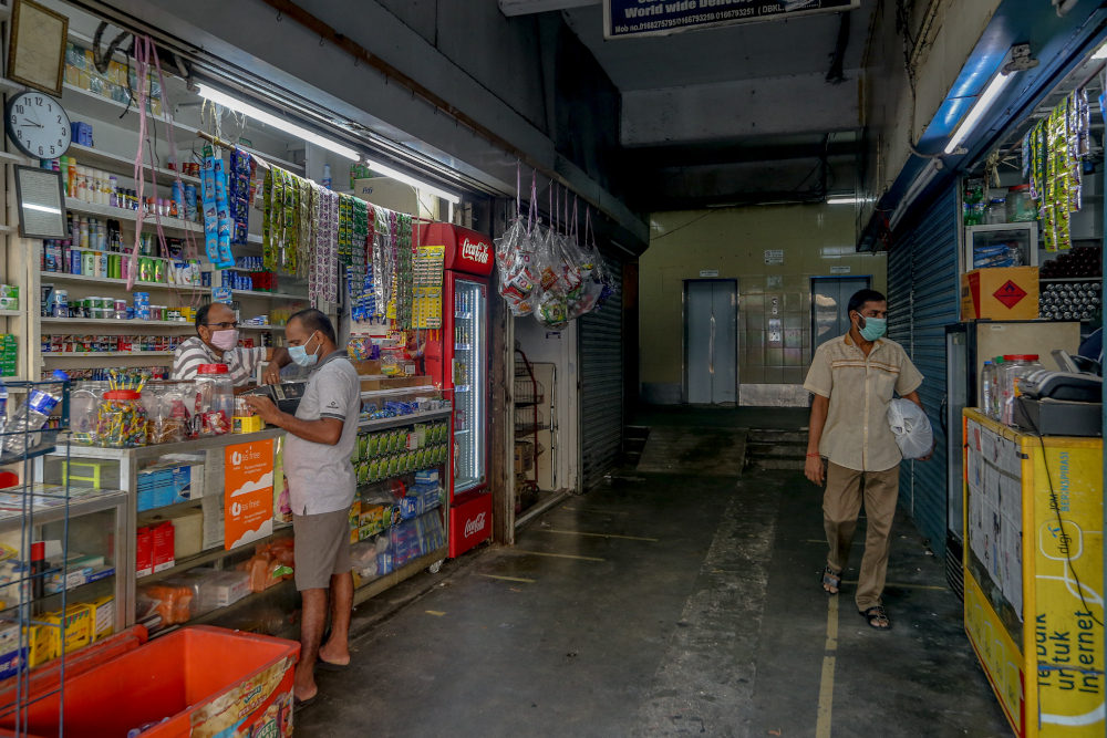 Workers prepare their shops for business during the conditional movement control order (CMCO) in Jalan Masjid India in Kuala Lumpur May 5, 2020. u00e2u20acu201d Picture by Firdaus Latif