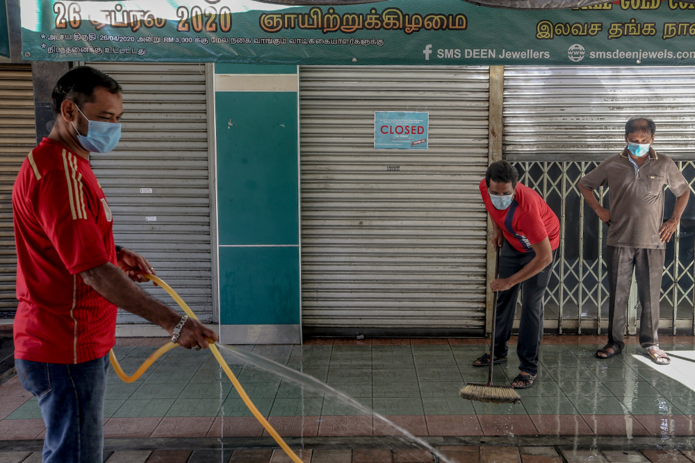 Workers prepare their shops for business during the conditional movement control order (CMCO) in Jalan Masjid India in Kuala Lumpur May 5, 2020. u00e2u20acu201d Picture by Firdaus Latif
