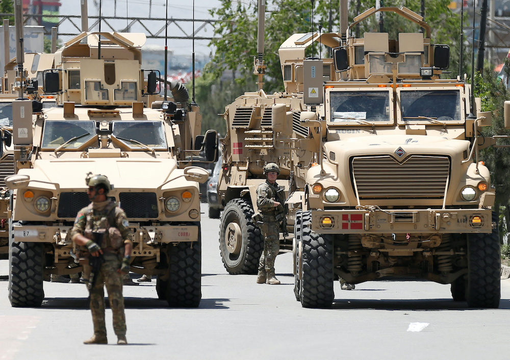 A foreign soldier keeps watch among armoured vehicles outside a hospital which came under attack in Kabul, Afghanistan May 12, 2020. u00e2u20acu201du00c2u00a0Reuters pic