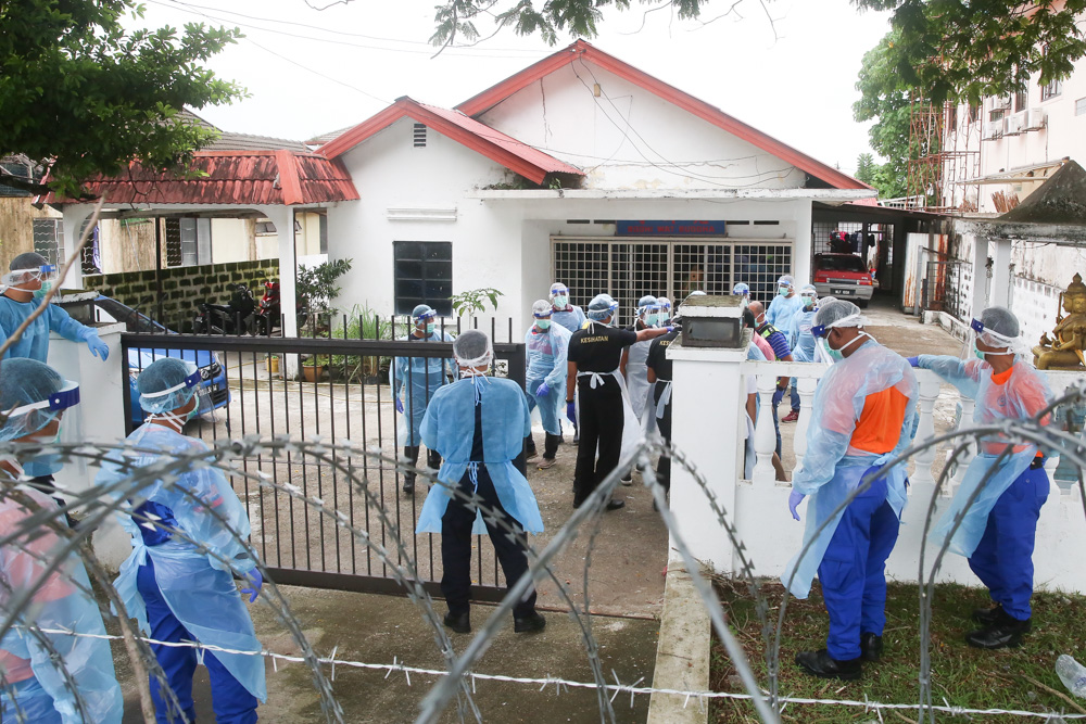 Police officers, health workers and RELA personnel go house to house to check on residents during the Petaling Jaya Old Town enhanced movement control order (EMCO) May 13, 2020. u00e2u20acu201d Picture by Choo Choy May