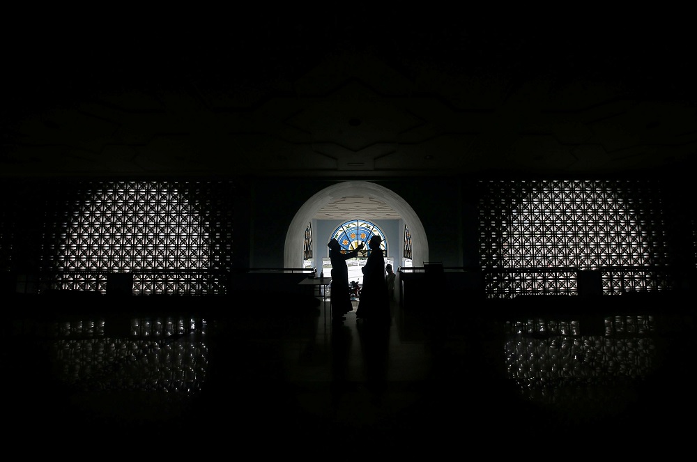 Muslim believers need to undergo the temperature check before attending the Friday prayers at Sultan Azlan Shah Mosque in Ipoh May 15, 2020. u00e2u20acu201d Picture by Farhan Najib