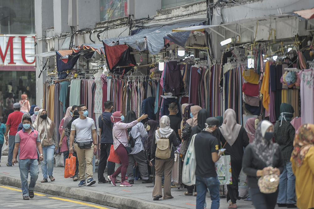 People are seen wearing masks as they go shopping at Jalan Tunku Abdul Rahman in Kuala Lumpur, May 17, 2020. u00e2u20acu201d Picture by Shafwan Zaidon