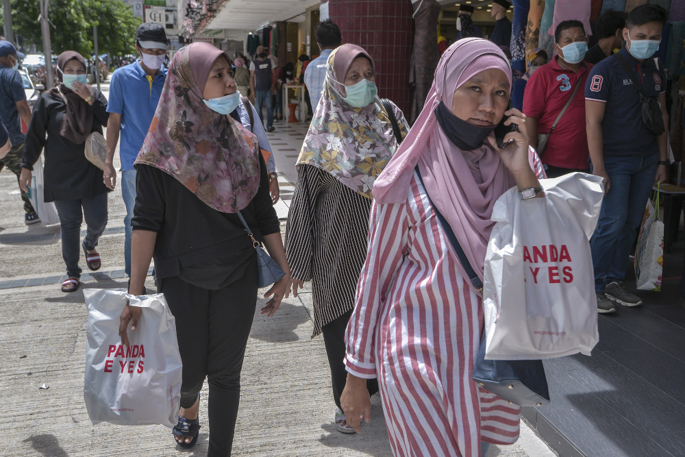 People are seen wearing masks as they go shopping at Jalan Tunku Abdul Rahman in Kuala Lumpur, May 17, 2020. u00e2u20acu201d Picture by Shafwan Zaidon