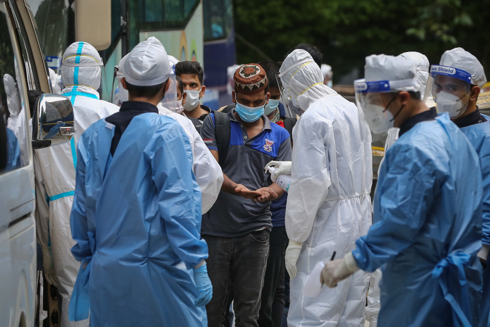 Foreign workers at a construction site in Jalan Ampang who came in close contact with Covid-19 patients board a bus and KKM van to a quarantine centre in Kuala Lumpur May 26, 2020. u00e2u20acu201d Picture by Yusof Mat Isa