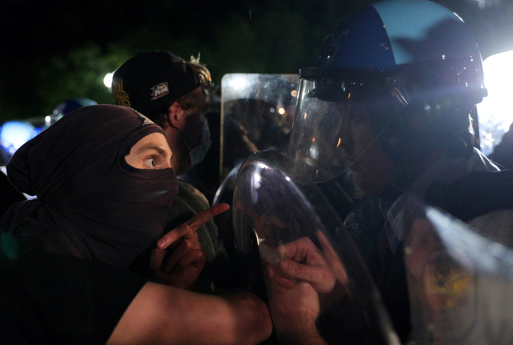 A protester faces a US Secret Service uniformed division officer during a demonstration against the death in police custody of African-American man George Floyd, at Lafayette Park in Washington May 30, 2020. u00e2u20acu201d Reuters pic