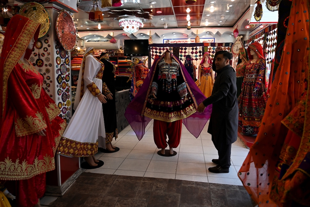 A shopkeeper displays a dress on a mannequin as he waits for customers during the government-imposed lockdown as a preventive measure against the Covid-19 coronavirus in Kabul. u00e2u20acu201d AFP pic