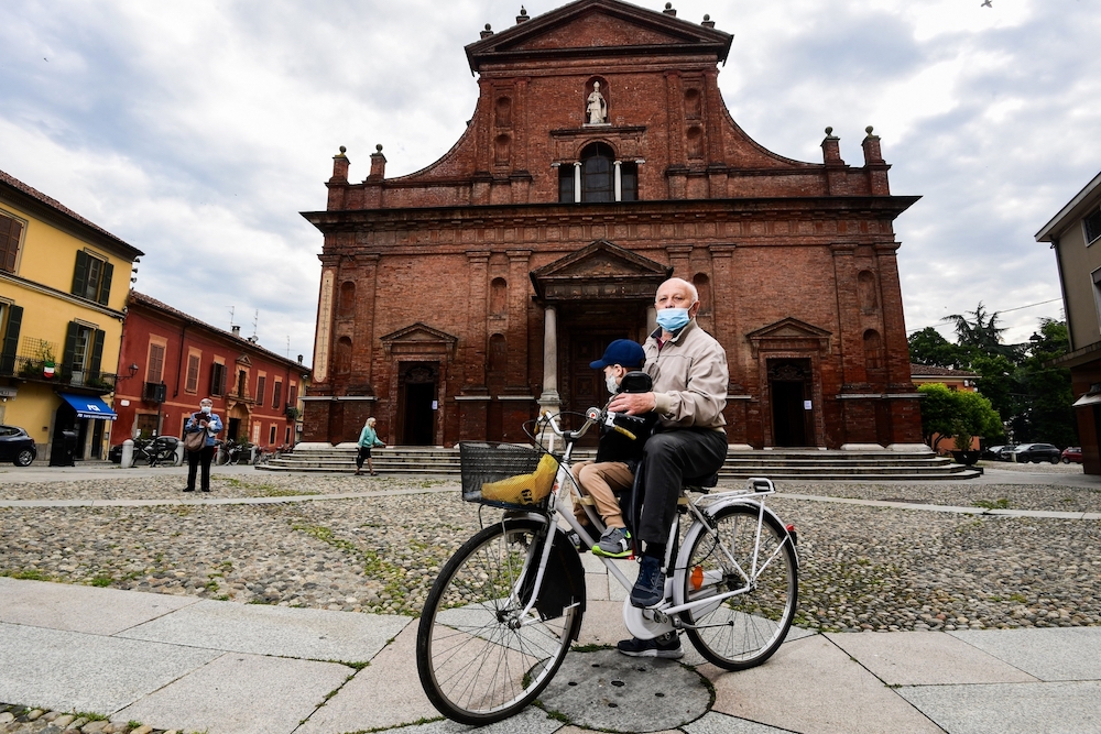 Codogno resident and 74-year-old pensioneer, Giancarlo Barcellesi poses on his bicycle outside the San Biagio and Santa Maria Immacolata church. u00e2u20acu201d AFP pic
