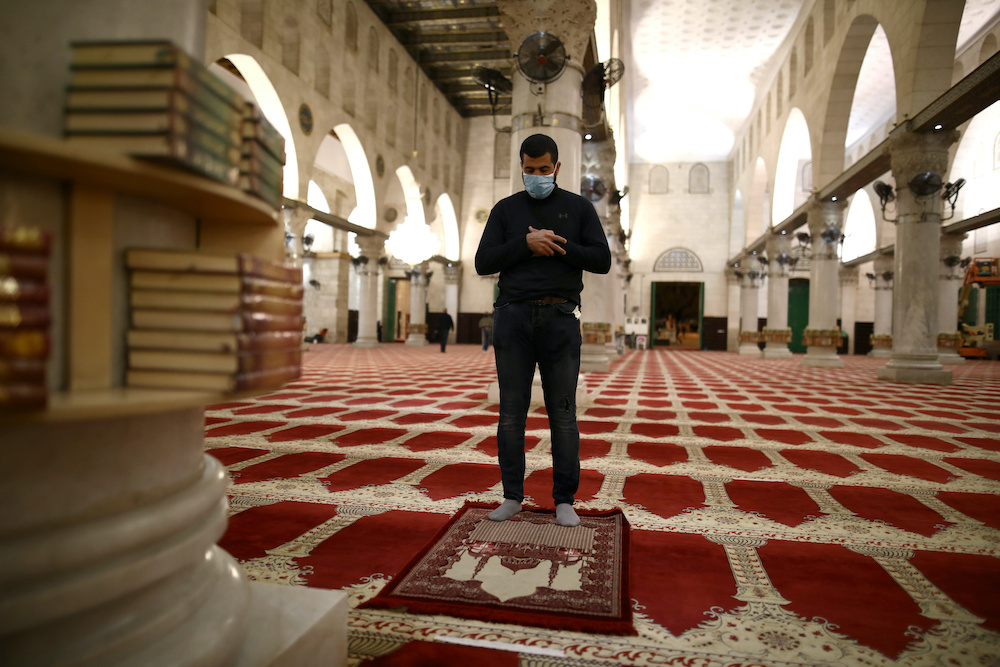 A worshipper wearing a mask prays inside al-Aqsa mosque as it reopened after a two-and-a-half month closure due to the coronavirus disease (Covid-19) spread in Jerusalem's Old City May 31, 2020. u00e2u20acu201d Reuters pic