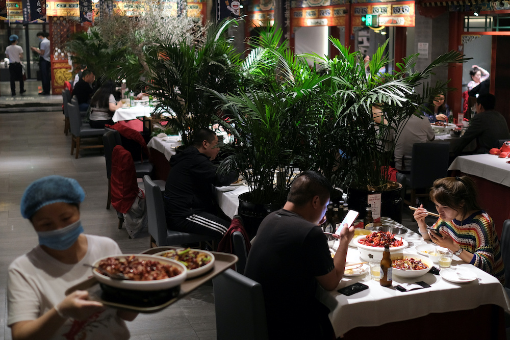 People enjoy their meal at a restaurant, following an outbreak of the coronavirus disease, in Beijing, China May 7, 2020. u00e2u20acu201d Reuters picnn