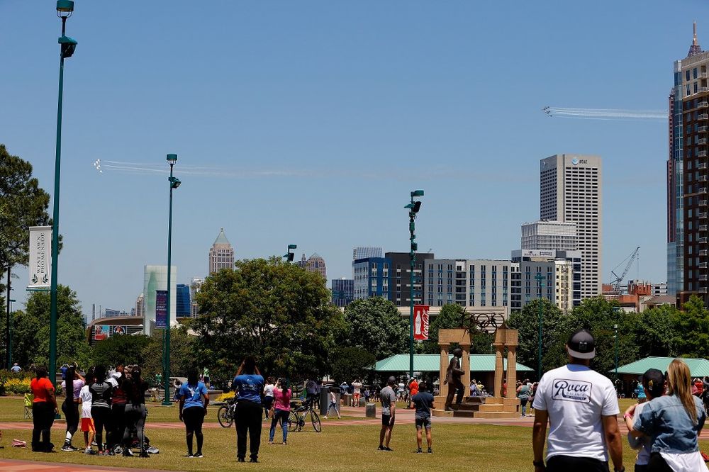 People look on as the US Navyu00e2u20acu2122s Blue Angels and US Air Forceu00e2u20acu2122s Thunderbirds perform a flyover around Centennial Olympic Park, May 2, 2020 in Atlanta, Georgia. The flight is a tribute to honour Atlanta Covid-19 frontline workers u00e2u20acu201d AFP pic