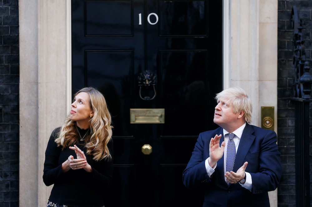Britainu00e2u20acu2122s Prime Minister Boris Johnson and partner Carrie Symonds applaud outside 10 Downing Street during the Clap for our Carers campaign in support of the NHS, following the outbreak of the coronavirus disease, London, Britain, May 14, 2020. u00e2u20acu201d Reut