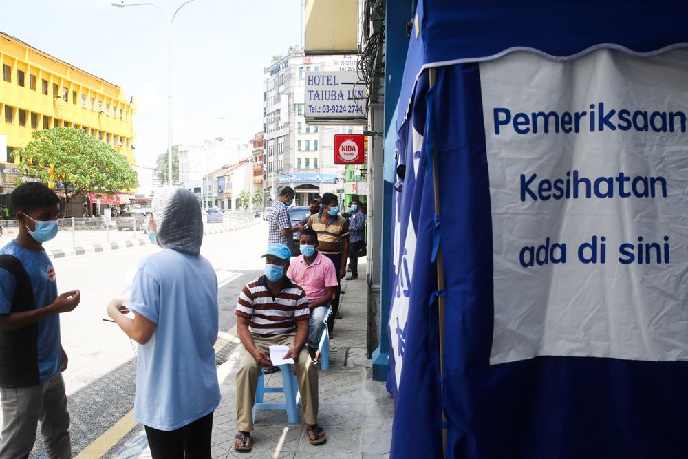 Foreign construction workers waiting in line to be screened for Covid-19 at a clinic in Pudu, May 15, 2020. u00e2u20acu201d Picture by Choo Choy May