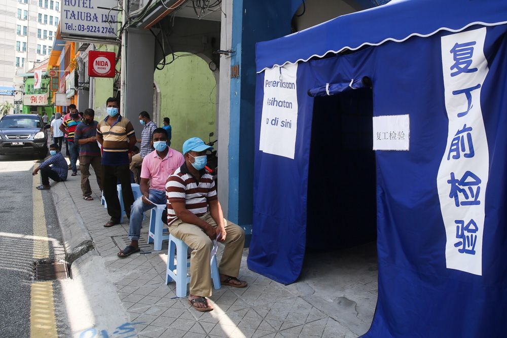 Foreign construction workers waiting in line to be screened for Covid-19 at a clinic in Pudu, May 15, 2020. u00e2u20acu201d Picture by Choo Choy May