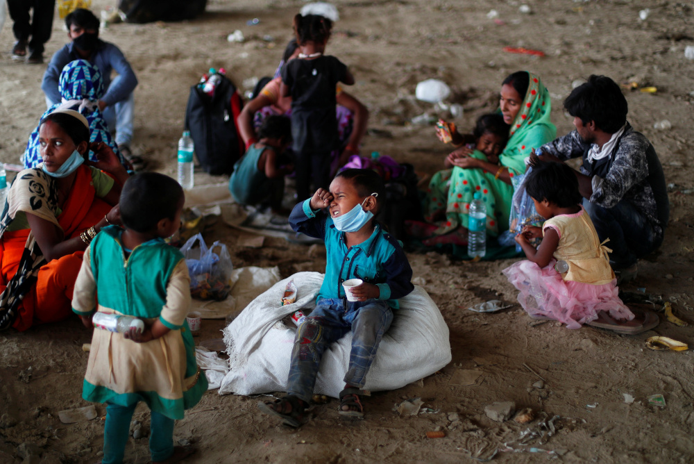 A migrant workeru00e2u20acu2122s son cries as they wait to cross the border to their home state of Uttar Pradesh, during an extended nationwide lockdown to slow the spread of the coronavirus disease, in New Delhi, India, May 17, 2020. u00e2u20acu201d Reuters pic 