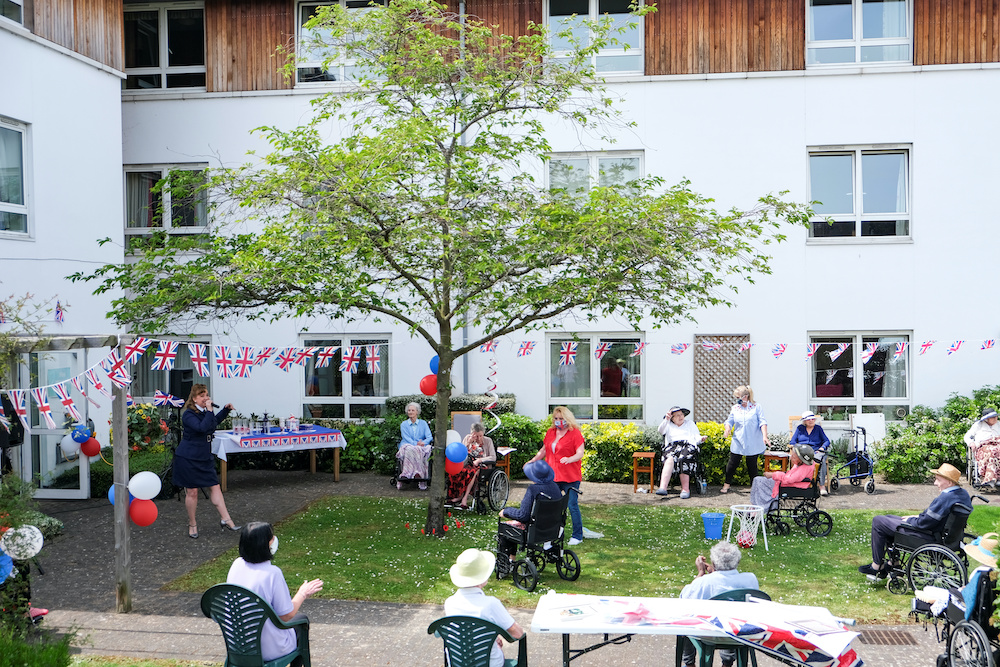 Singer Debbie Watt representing Care Entertainment sings 1940's songs on the 75th Anniversary of VE Day at the Ashgreen House Residential and Nursing Home in Woolwich, May 8, 2020. u00e2u20acu201d Reuters picnnn