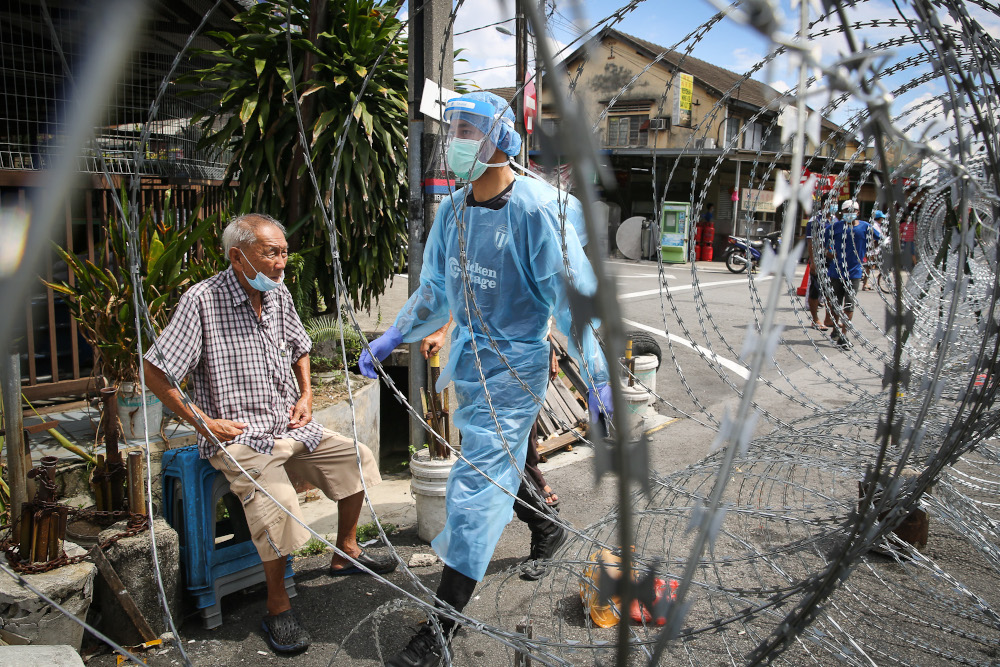 A Health worker wearing protective suits is pictured at the Old Town, Petaling Jaya during the enhanced movement control order May 12, 2020. u00e2u20acu201d Picture by Yusof Mat Isa