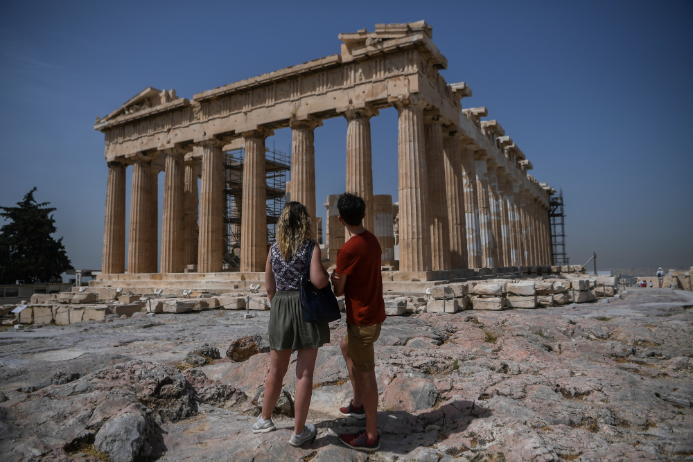 A couple visit the Parthenon temple on the archeological site of the Acropolis in Athens May 18, 2020 amid the pandemic of the novel coronavirus. u00e2u20acu201d AFP pic 