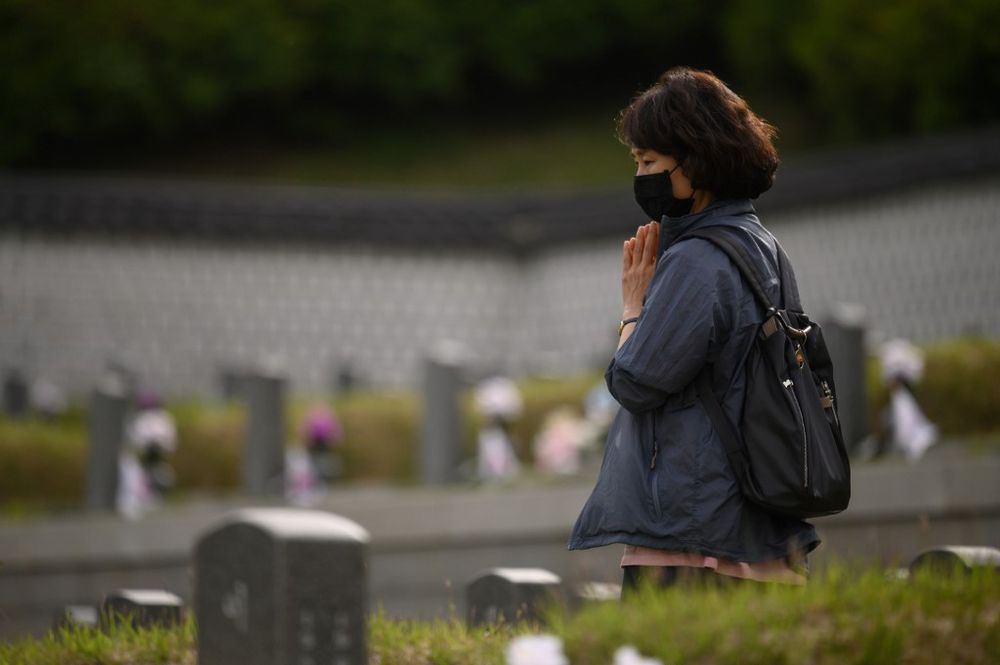 A visitor walking between graves at the May 18 National Cemetery for victims of the Gwangju pro-democracy movement, in Gwangju, May 14, 2020. u00e2u20acu201d AFP pic