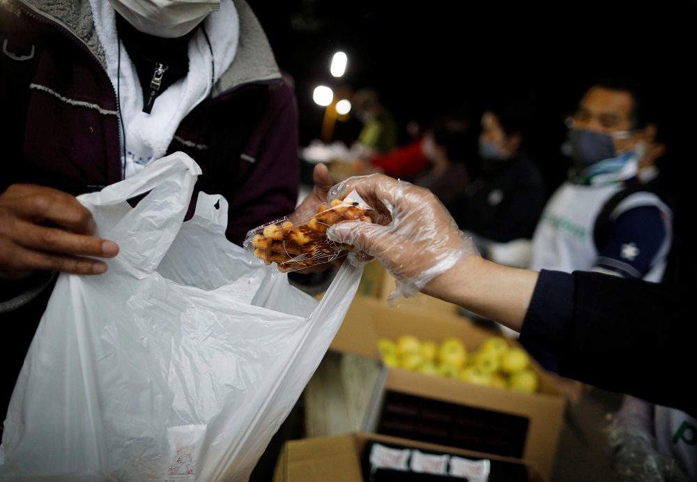 An elderly man receives food aid handouts for the needy, as the spread of the coronavirus disease continues in Tokyo May 9, 2020. u00e2u20acu2022 Reuters pic