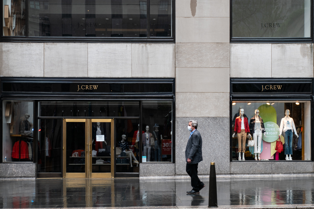 A person walks past a J. Crew Store on Madison Avenue May 1, 2020 in New York City. Clothing apparel company J. Crew is preparing for a file for bankruptcy protection. u00e2u20acu201d Jeenah Moon/Getty Images via AFP