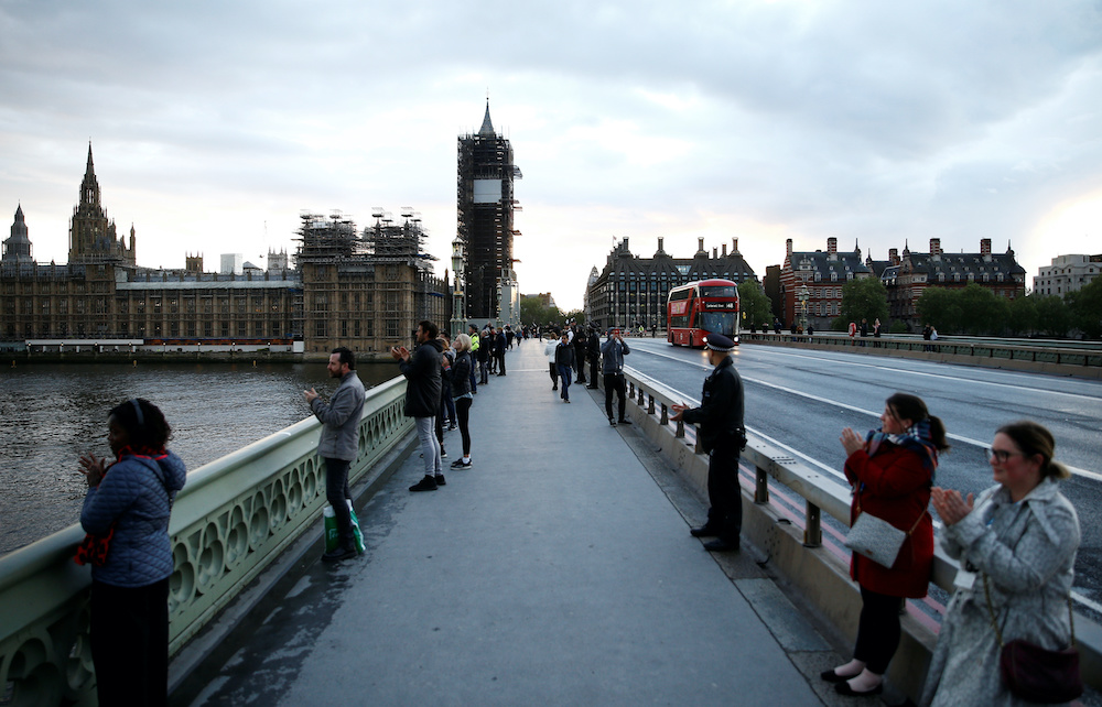 People applaud on Westminster Bridge during the Clap for our Carers campaign in support of the NHS, following the outbreak of the coronavirus disease, in London, Britain, April 30, 2020. u00e2u20acu201d Reuters picnn