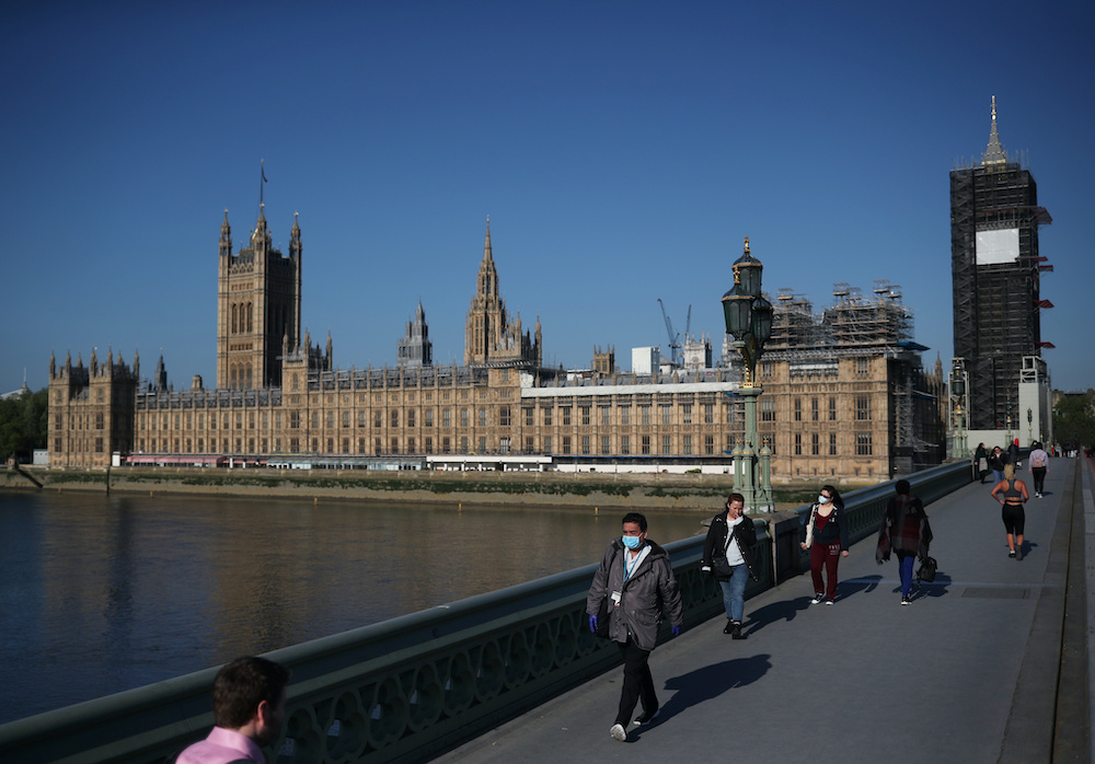 People walk across Westminster Bridge in London following the outbreak of the coronavirus disease, London, Britain, May 6, 2020. u00e2u20acu201d Reuters picnn