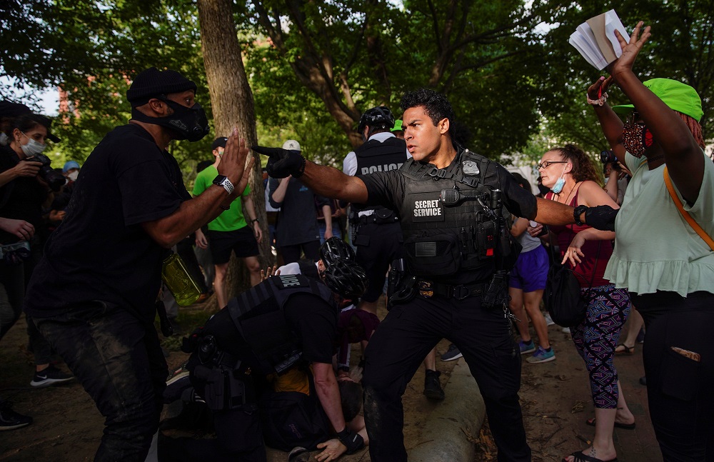 A US Secret Service uniformed division officer orders demonstrators back as other officers detain a protester on the ground in Lafayette Park in Washington May 29, 2020. u00e2u20acu2022 Reuters pic