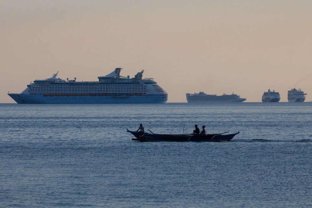 Fishermen sail past a group of cruise ships anchored in Manila Bay as its crew members undergo quarantine amid the coronavirus disease outbreak, in Manila, Philippines, May 8, 2020. u00e2u20acu201d Reuters pic