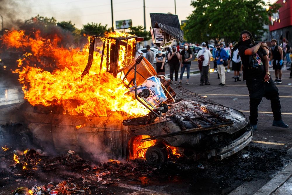 Protesters throw objects into a fire outside a Target store near the Third Police Precinct on May 28, 2020 in Minneapolis, Minnesota, during a demonstration over the death of George Floyd. u00e2u20acu201d AFP pic