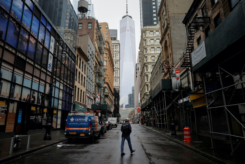 A man crosses a nearly deserted Fulton Street in the financial district in lower Manhattan during the outbreak of the coronavirus disease in New York City, New York, US, April 3, 2020. u00e2u20acu201d Reuters pic