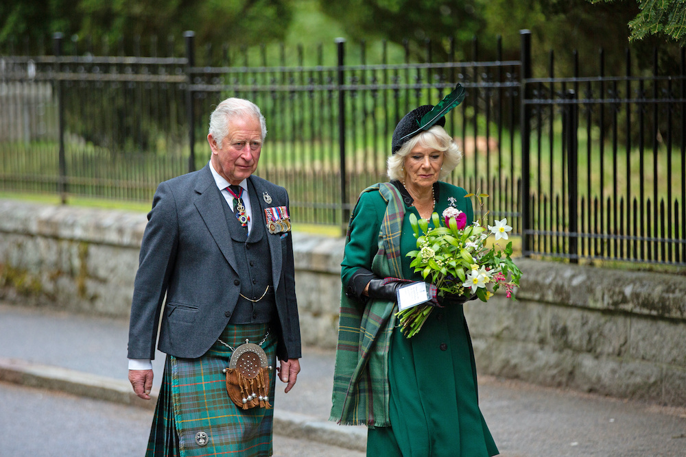 Picture released by Clarence House of Britain's Prince of Wales and the Duchess of Cornwall shows them walking to take part in a two-minute silence to mark the 75th anniversary of VE Day at the Balmoral War Memorial, Scotland, Britain May 8, 2020. u00e2u20acu201d Reu