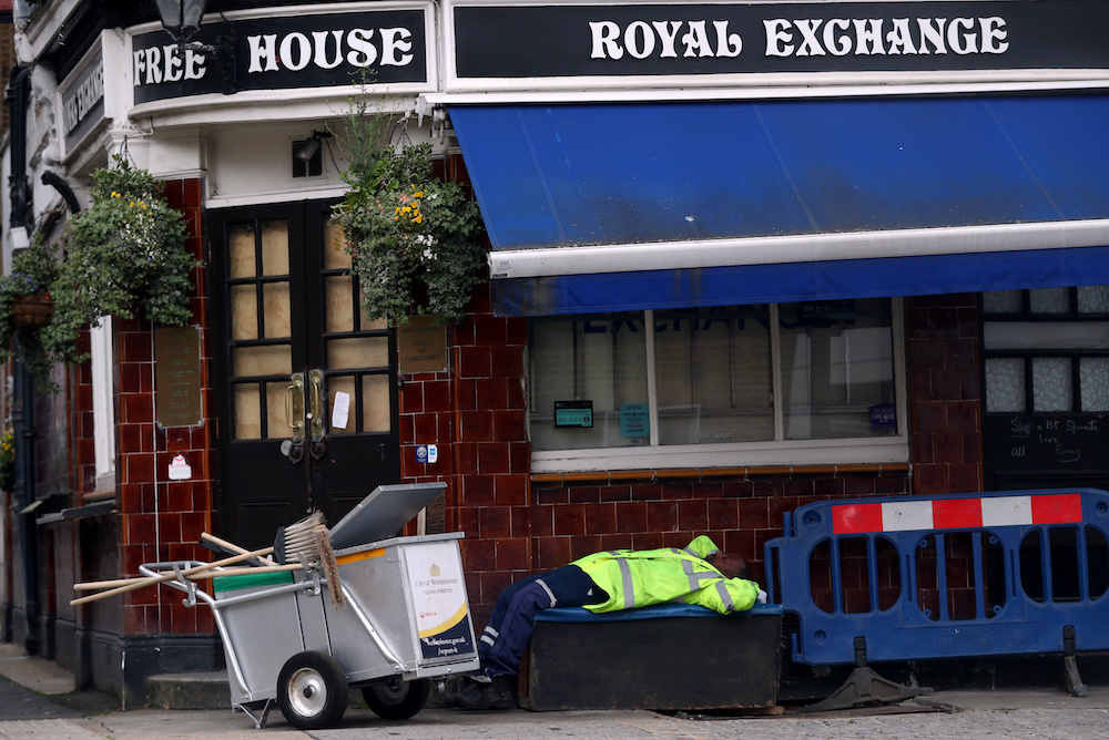 A streetcleaner naps outside a closed down pub in Westminster, as the spread of the coronavirus disease continues in London, Britain, April 29, 2020. u00e2u20acu201d Reuters picnn