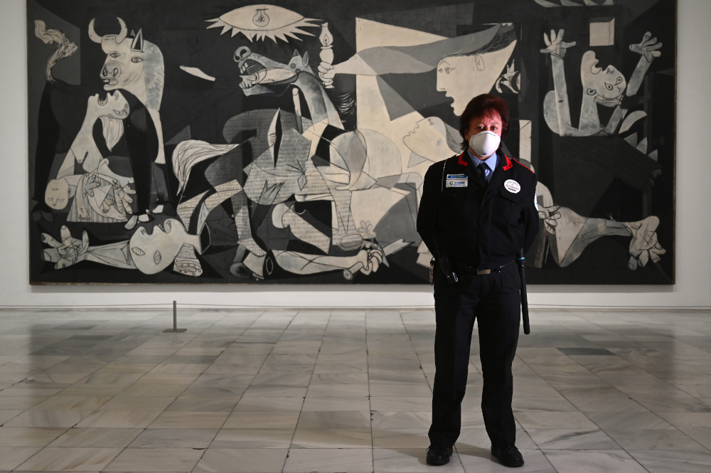 Spanish Mari Carmen Pinedo Cazorla, security guard, poses in front of Pablo Picassou00e2u20acu2122s masterpiece u00e2u20acu02dcGuernicau00e2u20acu2122 at the Reina Sofia museum in Madrid April 23, 2020 amid a national lockdown to fight the spread of the coronavirus. u00e2u20acu201d AFP pic 