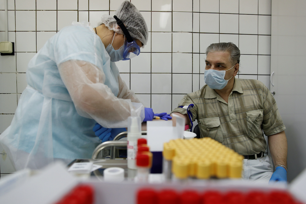 A healthcare worker takes blood samples from a man during testing for the coronavirus disease and antibodies at a clinic after authorities launched free mass screening for residents in the Russian capital, in Moscow, Russia May 15, 2020. u00e2u20acu201d Reuters pic