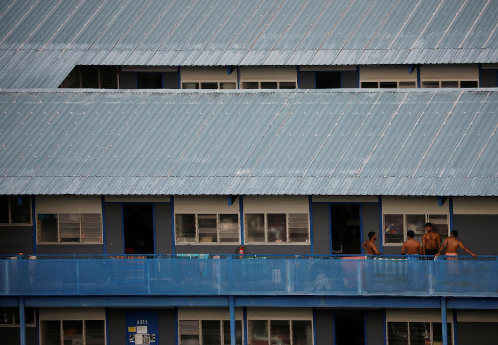 Migrant workers chat outside their rooms at a dormitory declared as an isolation area, amid the Covid-19 outbreak in Singapore, on May 4, 2020. u00e2u20acu201d Picture courtesy of TODAY nn