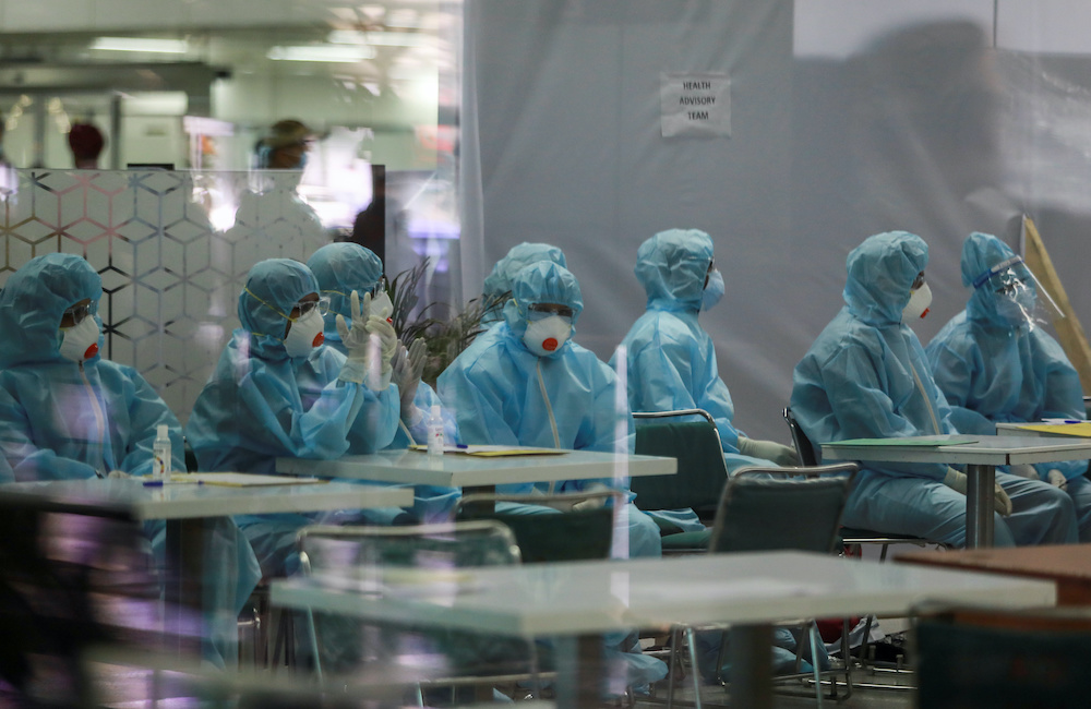 Medics wearing personal protective equipment prepare to screen Indian nationals, who were stranded in Singapore due to the coronavirus disease outbreak, at the airport upon their arrival in New Delhi, India, May 8, 2020. u00e2u20acu201d Reuters picnn
