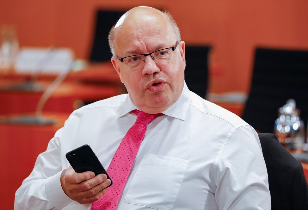 German Economy Minister Peter Altmaier holds his smartphone before the start of the weekly cabinet meeting on May 20, 2020 at the Chancellery in Berlin. u00e2u20acu201d AFP pic
