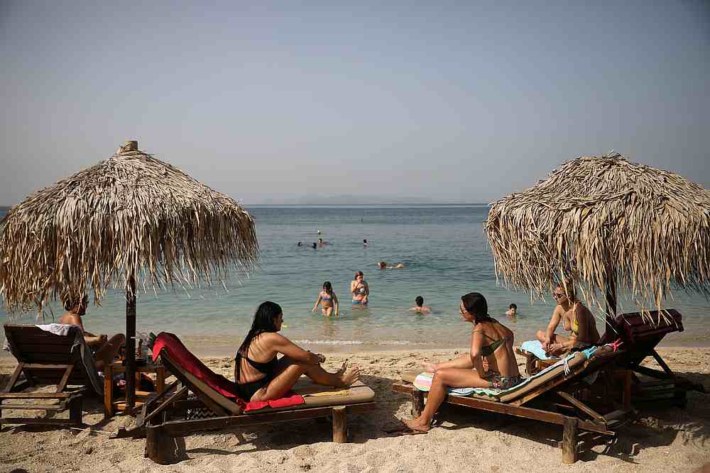 People enjoy the sun during the official reopening of beaches to the public following the easing of measures against the spread of Covid-19, in Athens, Greece May 16, 2020. u00e2u20acu201d Reuters pic