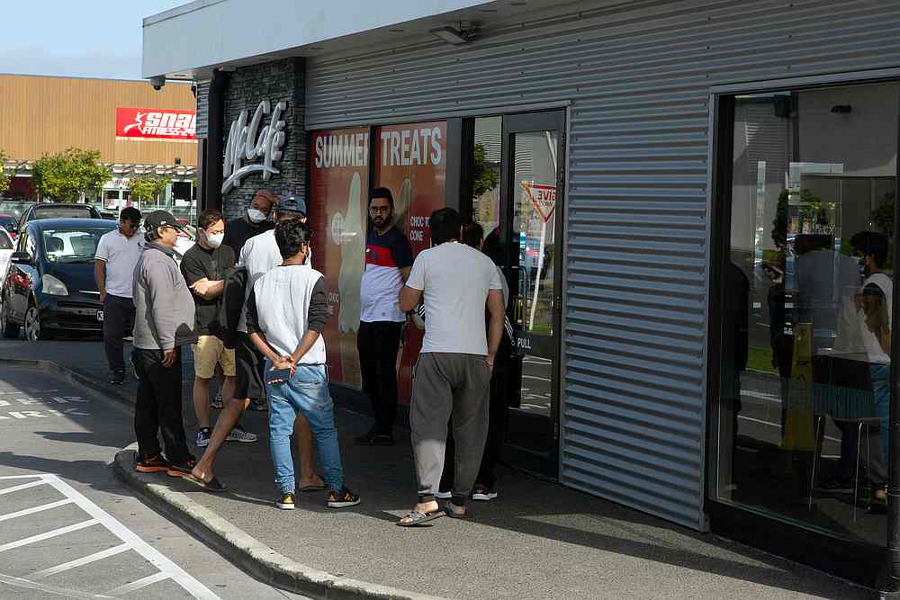 People wait to collect takeaway food at a McDonald's restaurant in the wake of New Zealand easing strict regulations in Auckland, New Zealand April 28, 2020. u00e2u20acu201d Reuters pic