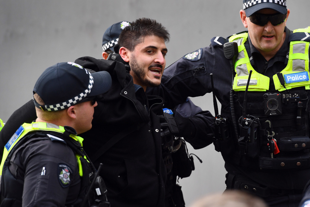 Fanos Panayides, a speaker at an anti-lockdown rally, is arrested on the steps of Victoriau00e2u20acu2122s state parliament in Melbourne May 10, 2020 along with nine other protesters. u00e2u20acu201d AFP pic 
