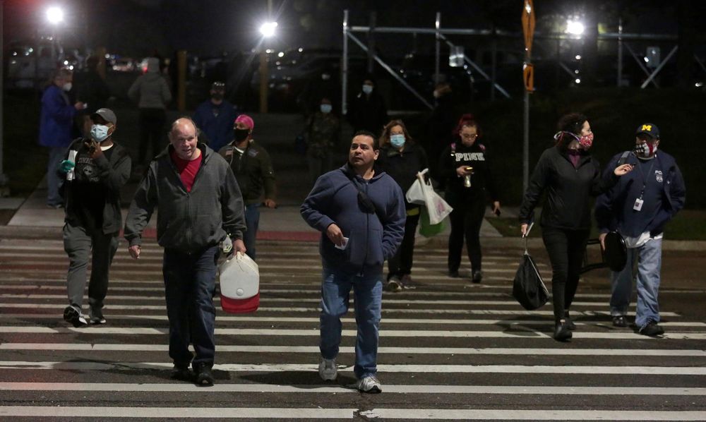 FCA assembly workers arrive for an early morning shift re-opening at the Warren Truck Assembly Plant, as the coronavirus disease (Covid-19) spread continues, in Warren, Michigan, US, May 18, 2020. u00e2u20acu201d Reuters pic