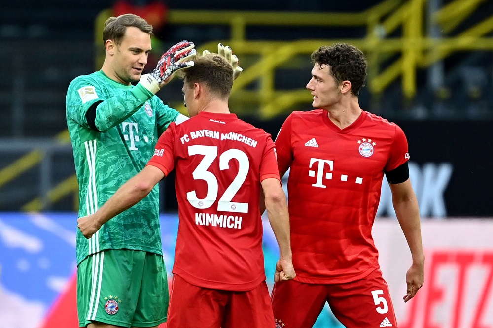 Bayern Munich's Manuel Neuer, Joshua Kimmich and Benjamin Pavard celebrate after the match against Borussia Dortmund, May 26, 2020. u00e2u20acu2022 Reuters pic